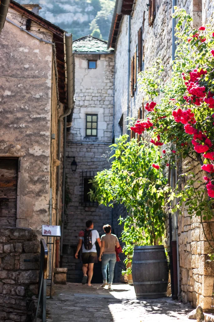 A couple strolling through the village of Sainte-Enimie.